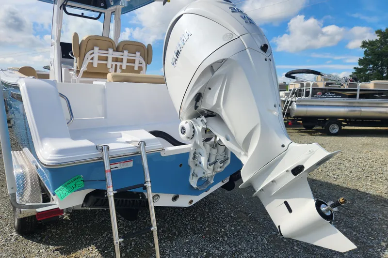 Slide: The Image of 2026 Sportsman Open 232 Center Console boat with Yamaha outboard motor, docked outdoors. - 3