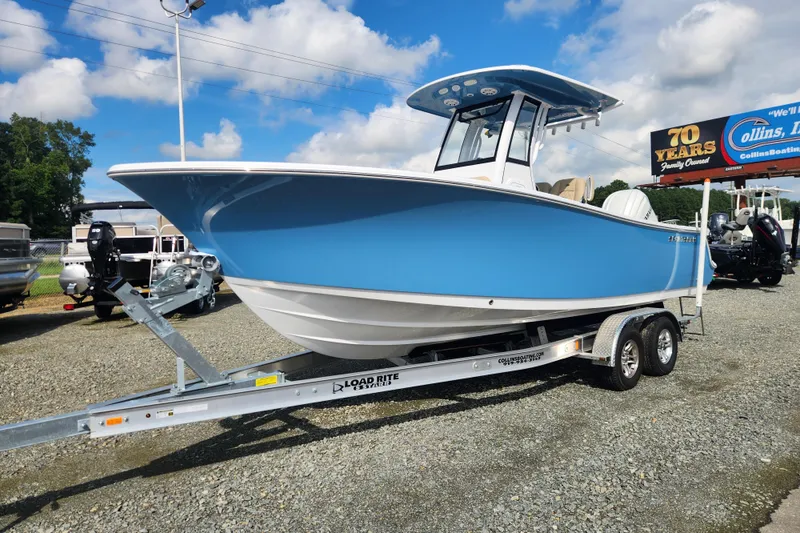 Slide: The Image of 2026 Sportsman Open 232 Center Console boat on trailer, displayed outdoors. - 6