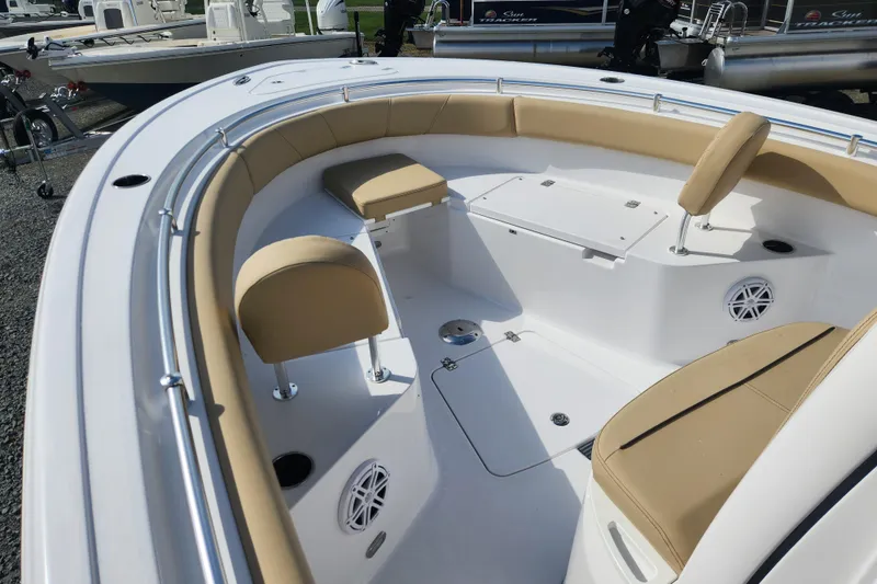 Slide: The Image of 2026 Sportsman Open 232 Center Console boat with tan seating and white deck. - 7