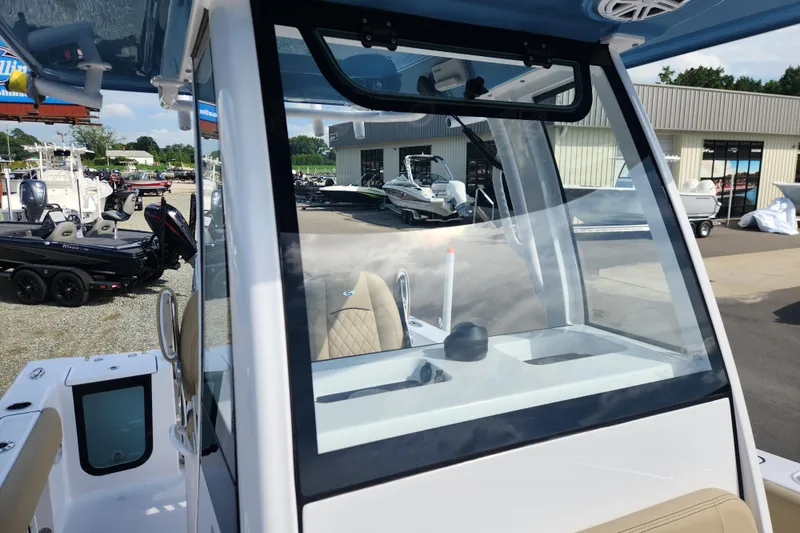 Slide: The Image of 2026 Sportsman Open 232 Center Console boat at a dealership, showcasing interior and exterior features. - 9