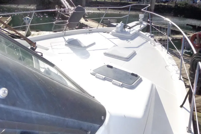 Slide: The Image of 1999 Bayliner 4788 Pilot House Motoryacht deck view at marina. - 10
