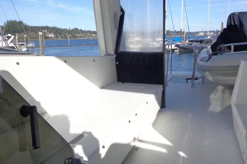 Slide: The Image of 1999 Bayliner 4788 Pilot House Motoryacht deck with marina view. - 13