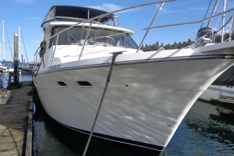 Slide: The Image of 1999 Bayliner 4788 Pilot House Motoryacht docked at marina, side view. - 3
