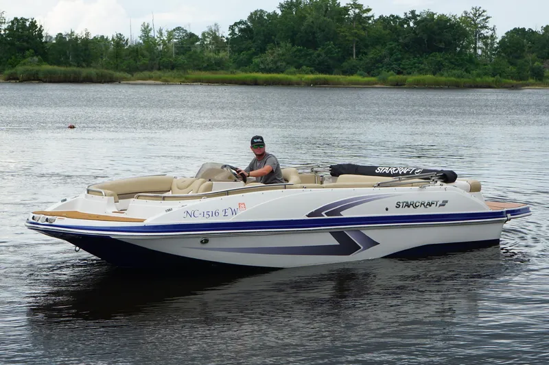 The Image of 2017 Starcraft Star Step 221 I/O boat on calm water with driver. - 0