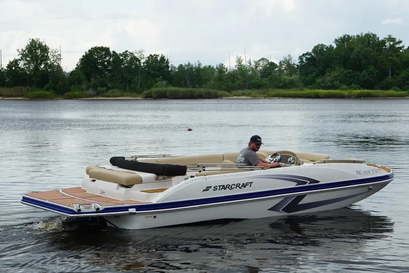 Slide: The Image of 2017 Starcraft Star Step 221 I/O boat cruising on a calm lake. - 11