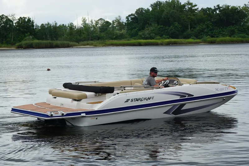 Slide: The Image of 2017 Starcraft Star Step 221 I/O boat cruising on a calm lake. - 12