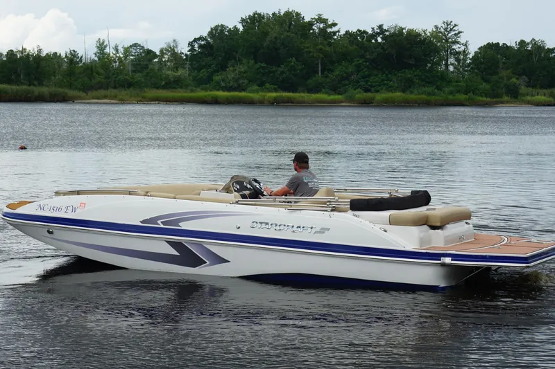 Slide: The Image of 2017 Starcraft Star Step 221 I/O boat cruising on a calm lake. - 13