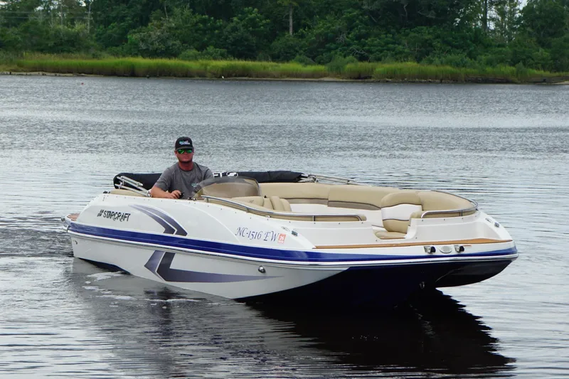 Slide: The Image of 2017 Starcraft Star Step 221 I/O boat on calm water, with lush greenery in background. - 14