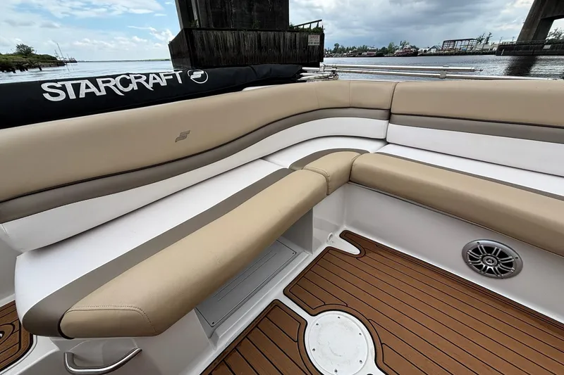 Slide: The Image of 2017 Starcraft Star Step 221 I/O boat interior with beige seating and wood-style flooring. - 18