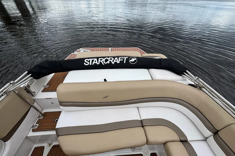 Slide: The Image of 2017 Starcraft Star Step 221 I/O boat interior with tan seating on water. - 19