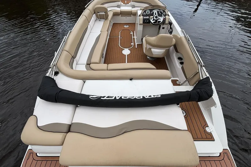 Slide: The Image of 2017 Starcraft Star Step 221 I/O boat with beige seating and wood accents on water. - 4