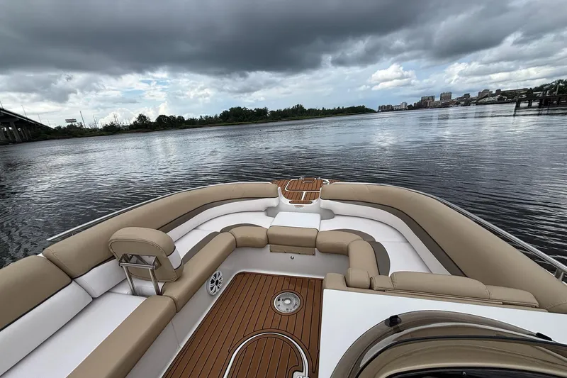 Slide: The Image of 2017 Starcraft Star Step 221 I/O boat interior with tan seating on a calm river. - 5