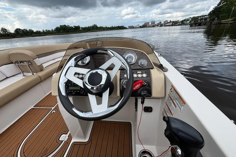 Slide: The Image of 2017 Starcraft Star Step 221 I/O boat interior with steering wheel, dashboard, and seating. - 7