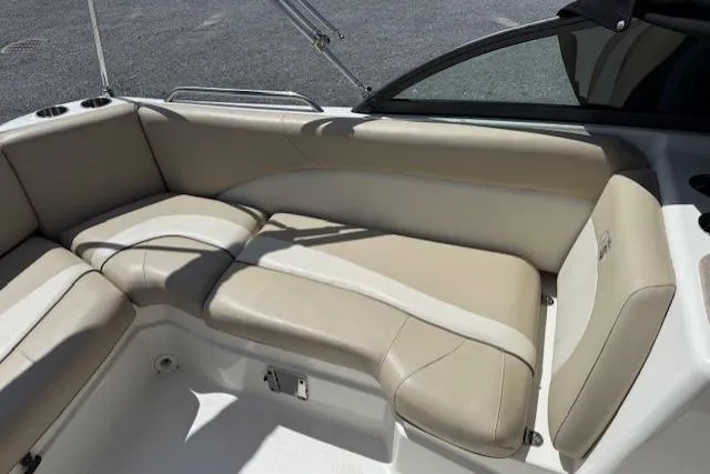 Slide: The Image of 2017 NauticStar 203DC Sport Deck boat interior with beige seating and cup holders. - 11