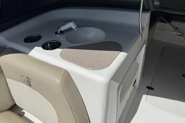 Slide: The Image of 2017 NauticStar 203DC Sport Deck interior with sink and cup holders. - 12