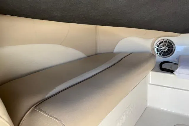Slide: The Image of 2017 NauticStar 203DC Sport Deck interior with beige seating and speaker. - 15