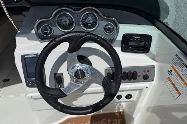 Slide: The Image of 2017 NauticStar 203DC Sport Deck dashboard with steering wheel and gauges. - 6
