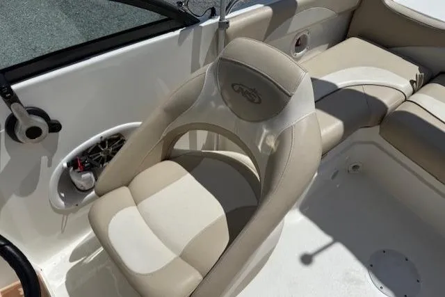 Slide: The Image of 2017 NauticStar 203DC Sport Deck boat interior with beige seating and speaker system. - 9