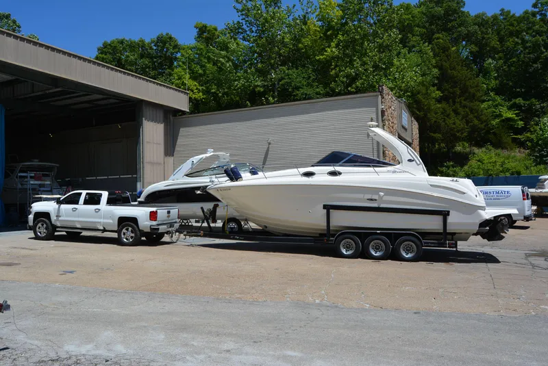 Slide: The Image of 2004 Sea Ray 300 Sundancer on trailer, parked outside a storage facility. - 13