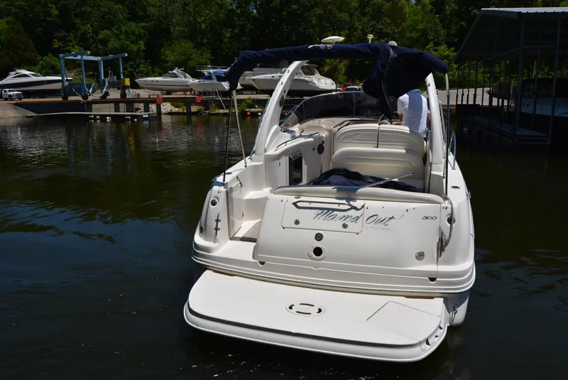 Slide: The Image of 2004 Sea Ray 300 Sundancer boat docked in a marina, rear view. - 14
