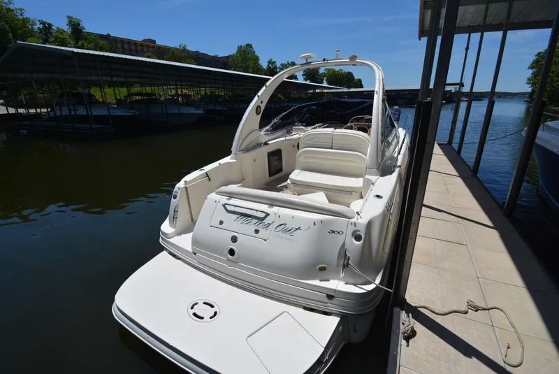 Slide: The Image of 2004 Sea Ray 300 Sundancer docked, rear view, sunny day, marina setting. - 20