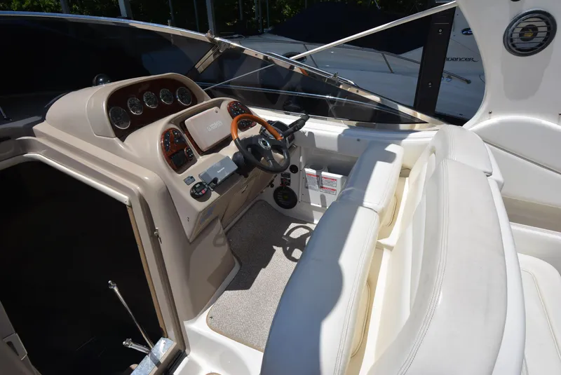 Slide: The Image of 2004 Sea Ray 300 Sundancer helm with steering wheel and instrument panel. - 27