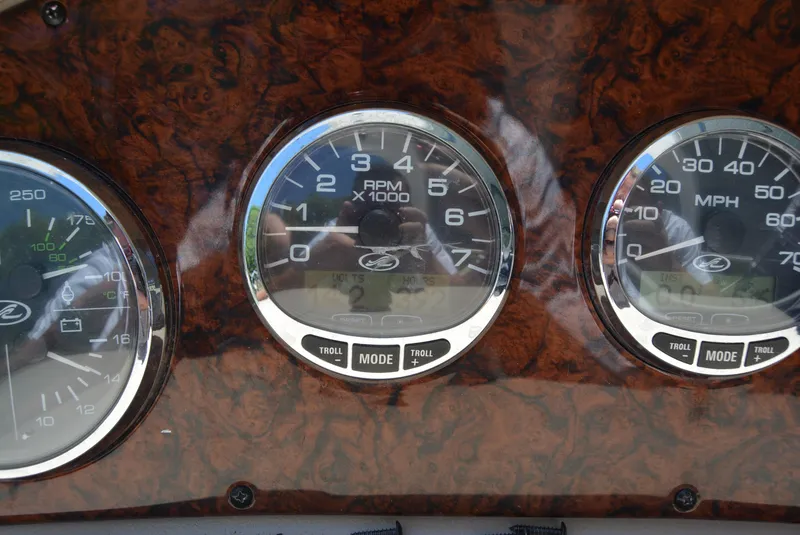 Slide: The Image of Dashboard gauges of a 2004 Sea Ray 300 Sundancer boat. - 28