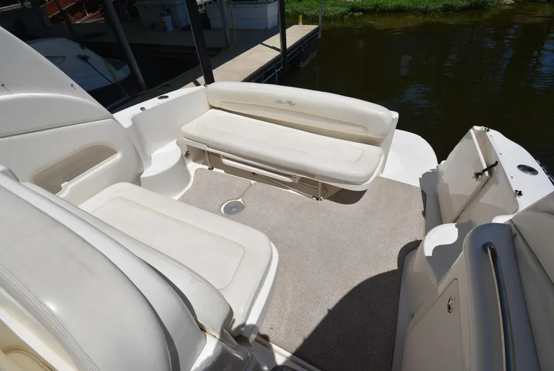 Slide: The Image of 2004 Sea Ray 300 Sundancer boat interior with white seating and carpeted floor. - 31