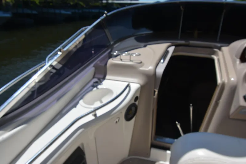 Slide: The Image of 2004 Sea Ray 300 Sundancer boat interior with seating and control panel. - 34