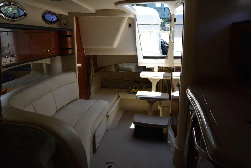 Slide: The Image of Interior of 2004 Sea Ray 300 Sundancer yacht, featuring seating and compact design. - 35
