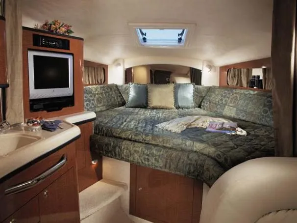 Slide: The Image of Luxurious interior of 2004 Sea Ray 300 Sundancer with cozy bed and entertainment area. - 38