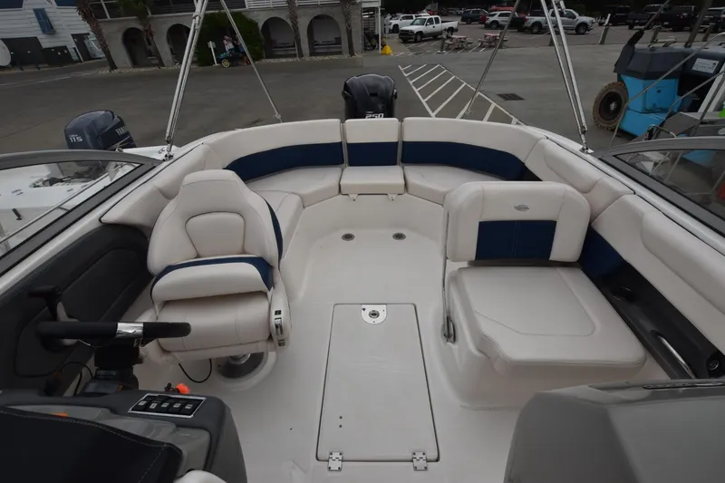 Slide: The Image of 2018 Chaparral 230 Suncoast boat interior with white and blue seating. - 10
