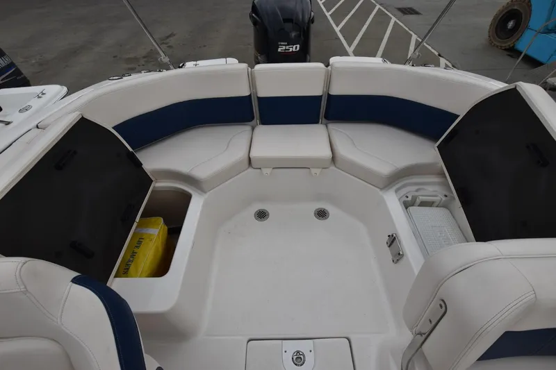 Slide: The Image of 2018 Chaparral 230 Suncoast boat interior with white and blue seating. - 11