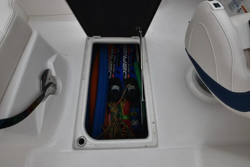 Slide: The Image of Storage compartment on 2018 Chaparral 230 Suncoast boat with water sports equipment. - 12