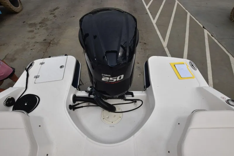 Slide: The Image of 2018 Chaparral 230 Suncoast boat with Yamaha 250 outboard engine, docked on concrete. - 13