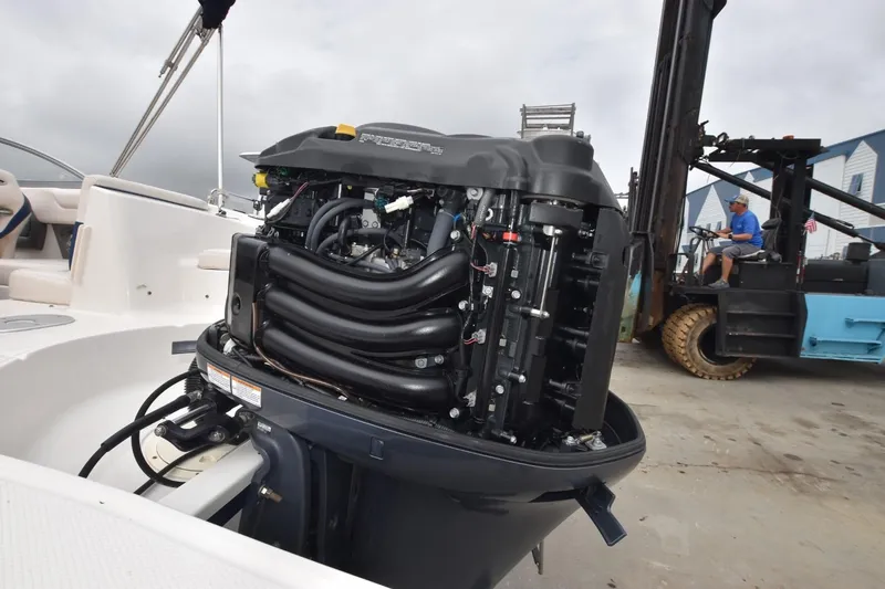 Slide: The Image of 2018 Chaparral 230 Suncoast boat engine exposed, with forklift in background. - 14