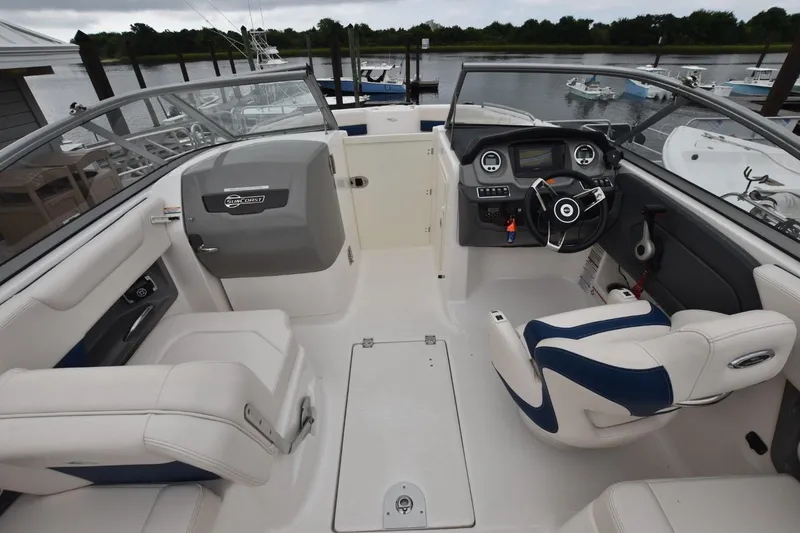 Slide: The Image of 2018 Chaparral 230 Suncoast boat interior with steering wheel and seating. - 8