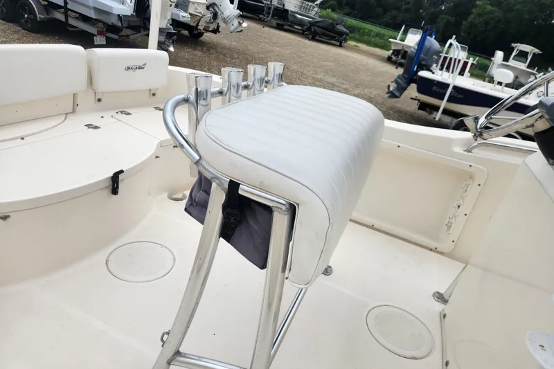 Slide: The Image of 2016 Bulls Bay 200 Center Console boat interior with white seating and rod holders. - 5