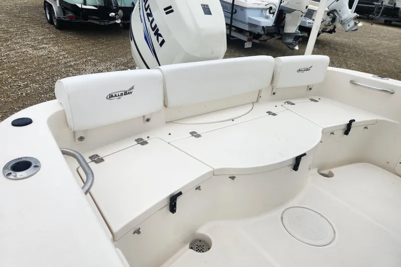Slide: The Image of 2016 Bulls Bay 200 Center Console boat interior with seating and storage compartments. - 7