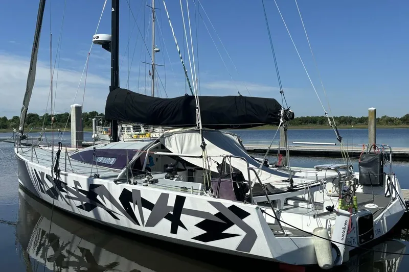 The Image of Sleek 2009 Akilaria RC2 Class 40 sailboat docked, featuring bold geometric design. - 0