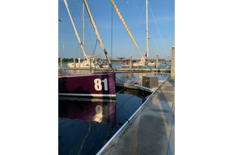 Slide: The Image of Sailboat "81" docked, Class 40 Akilaria RC2, 2009 model, in a marina setting. - 17
