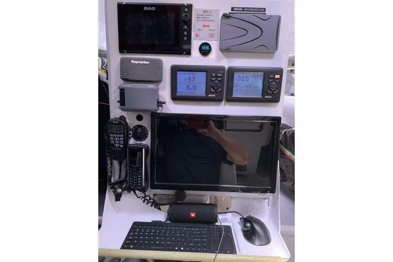 Slide: The Image of Navigation equipment on 2009 Class 40 Akilaria RC2 sailboat, featuring monitors and communication devices. - 20
