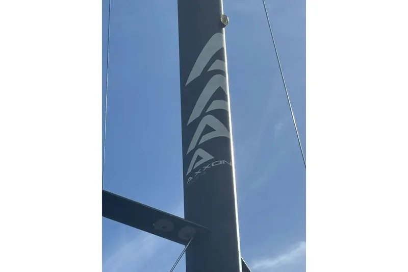 Slide: The Image of Mast of 2009 Class 40 Akilaria RC2 sailboat against clear blue sky. - 26