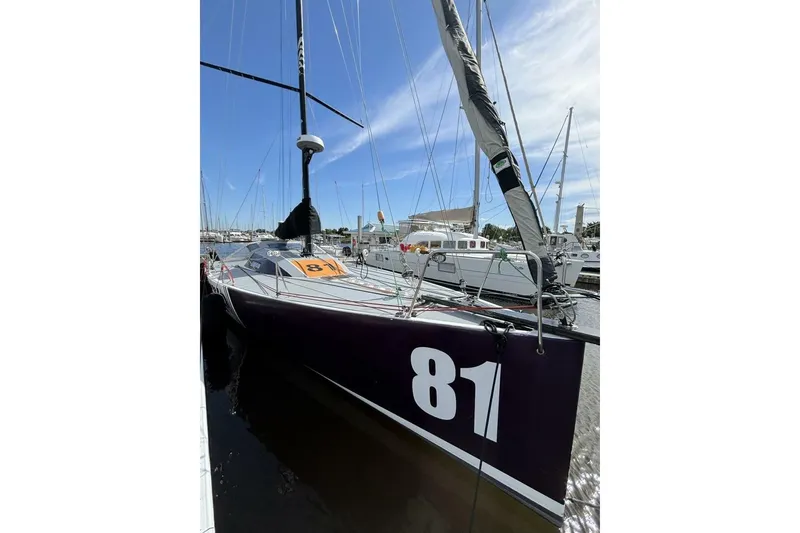 Slide: The Image of Sailboat Akilaria RC2 Class 40, 2009 model, docked with number 81 displayed. - 29