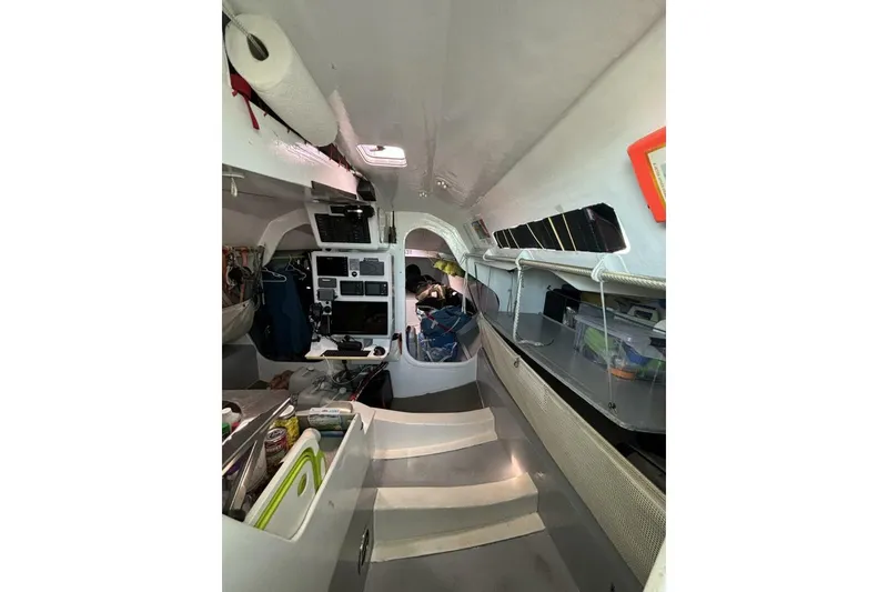 Slide: The Image of Interior of 2009 Class 40 Akilaria RC2 sailboat, featuring navigation equipment and storage. - 39