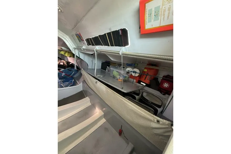 Slide: The Image of Interior of 2009 Class 40 Akilaria RC2 sailboat with organized storage and safety equipment. - 40