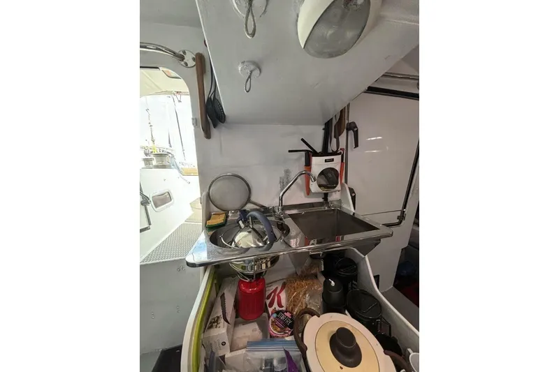 Slide: The Image of Interior of 2009 Class 40 Akilaria RC2 yacht, featuring compact kitchen area. - 43