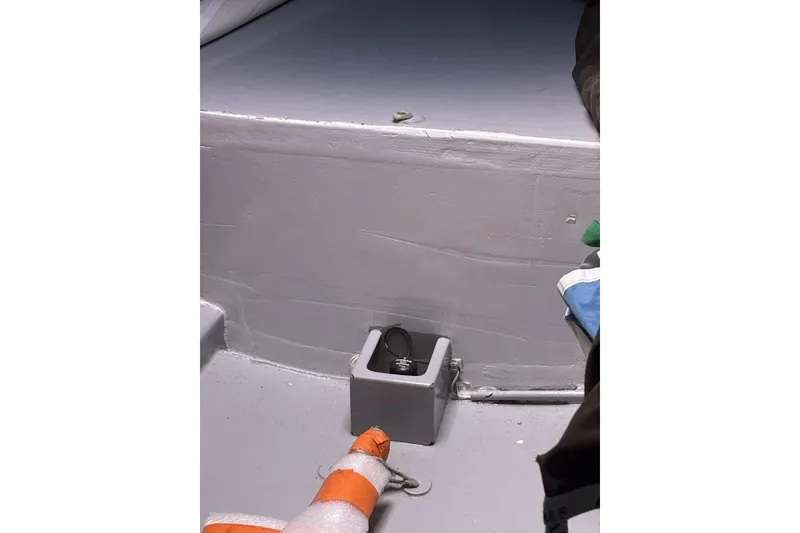 Slide: The Image of Interior of 2009 Class 40 Akilaria RC2 sailboat, featuring a storage compartment and safety equipment. - 44