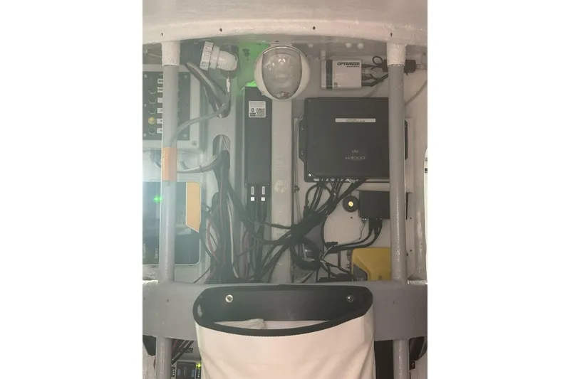 Slide: The Image of Electrical panel inside 2009 Class 40 Akilaria RC2 yacht, featuring wiring and equipment. - 46