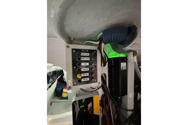 Slide: The Image of Control panel inside 2009 Class 40 Akilaria RC2 yacht, featuring switches and wiring. - 48